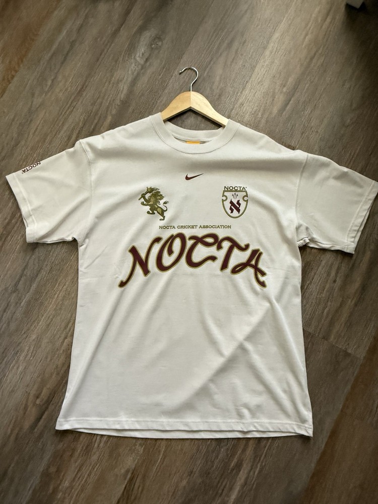 Nike NOCTA Cricket Association Tee – Size M – Light Orewood Brown IB5673-104