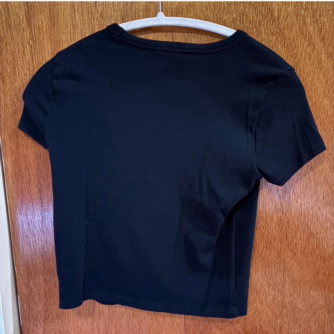 Tee from Garage, size s. Struggled to put on hanger, not actually off center. gallery