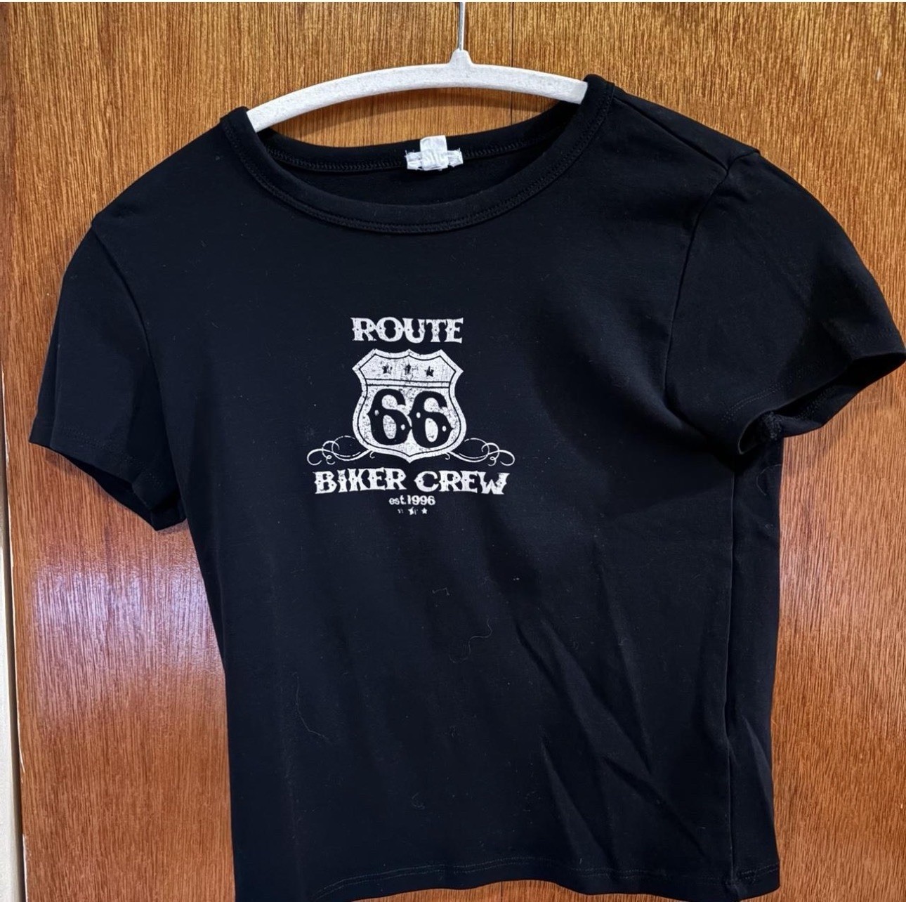 Tee from Garage, size s. Struggled to put on hanger, not actually off center. gallery