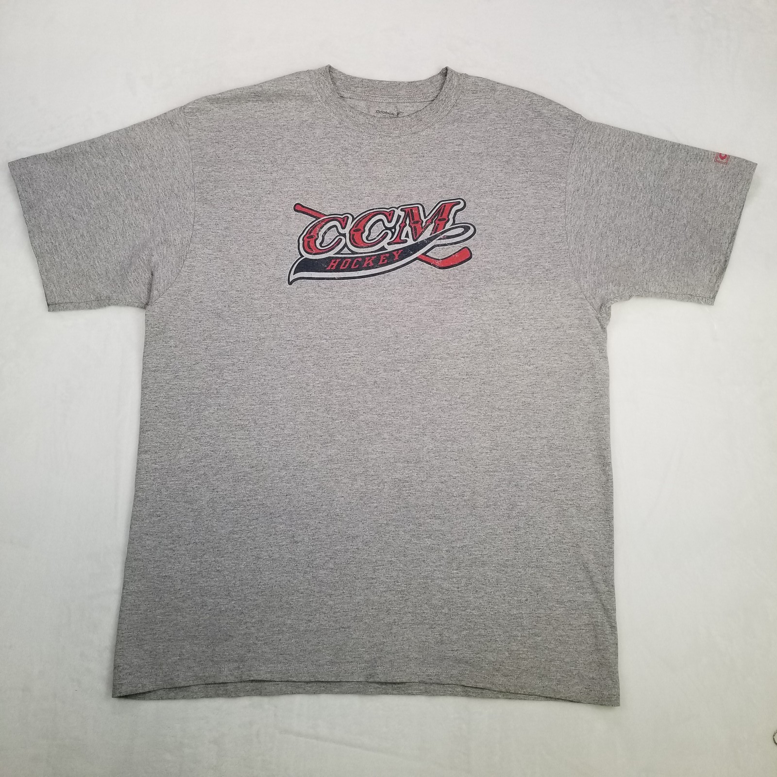 Reebok CCM Hockey Men’s Gray T-Shirt Size Large with Crossed Hockey Sticks Logo