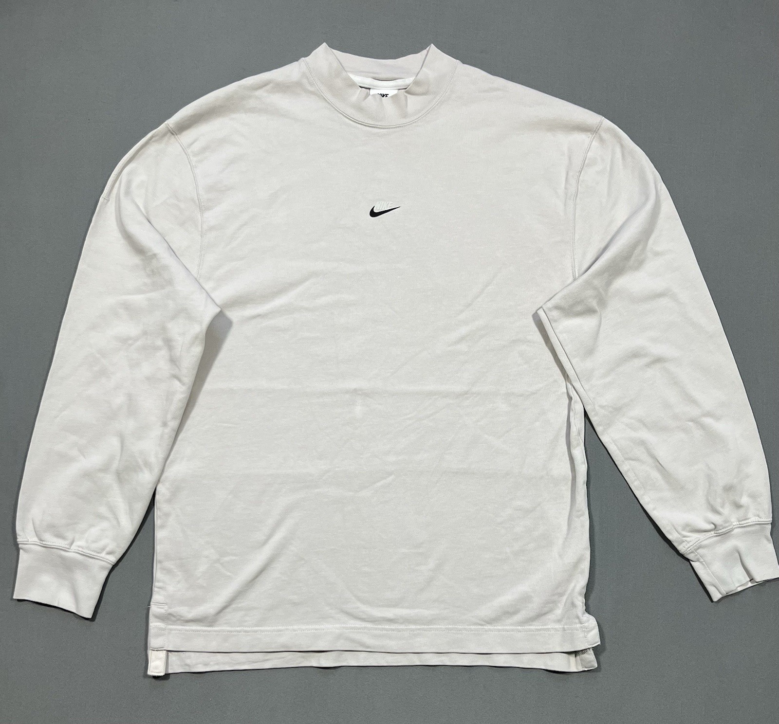 Nike long sleeve mock neck top in Light Bone featuring a small swoosh logo gallery