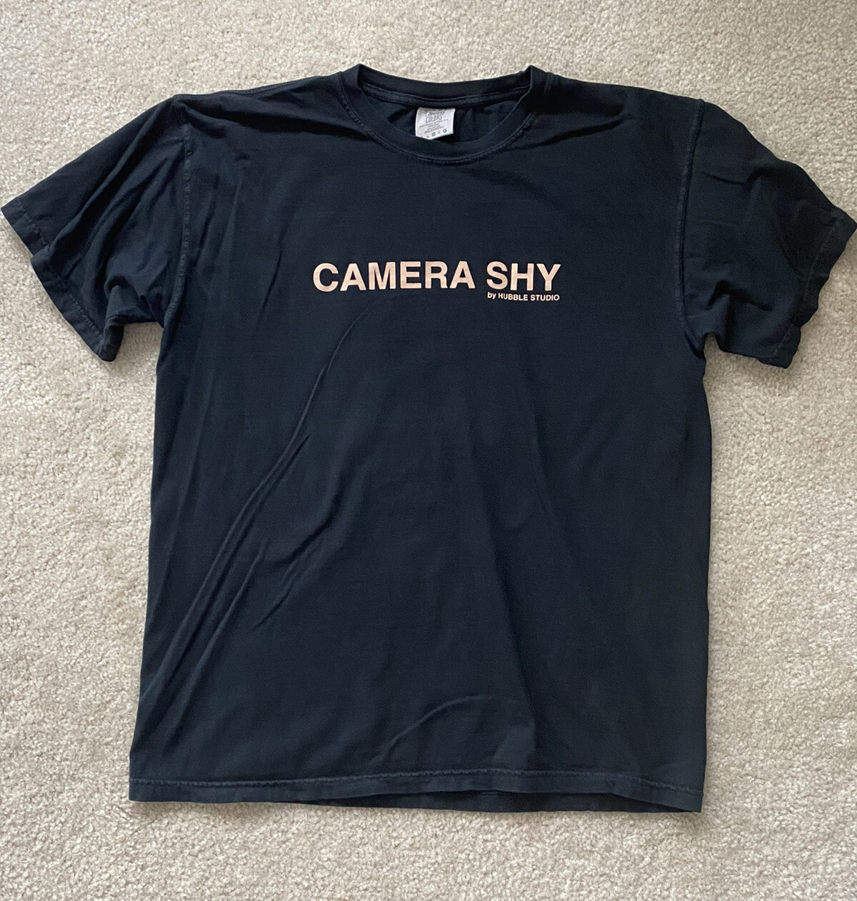 Hubble Studios “Camera Shy” T-Shirt, Black. Sizes Small, Medium, Large