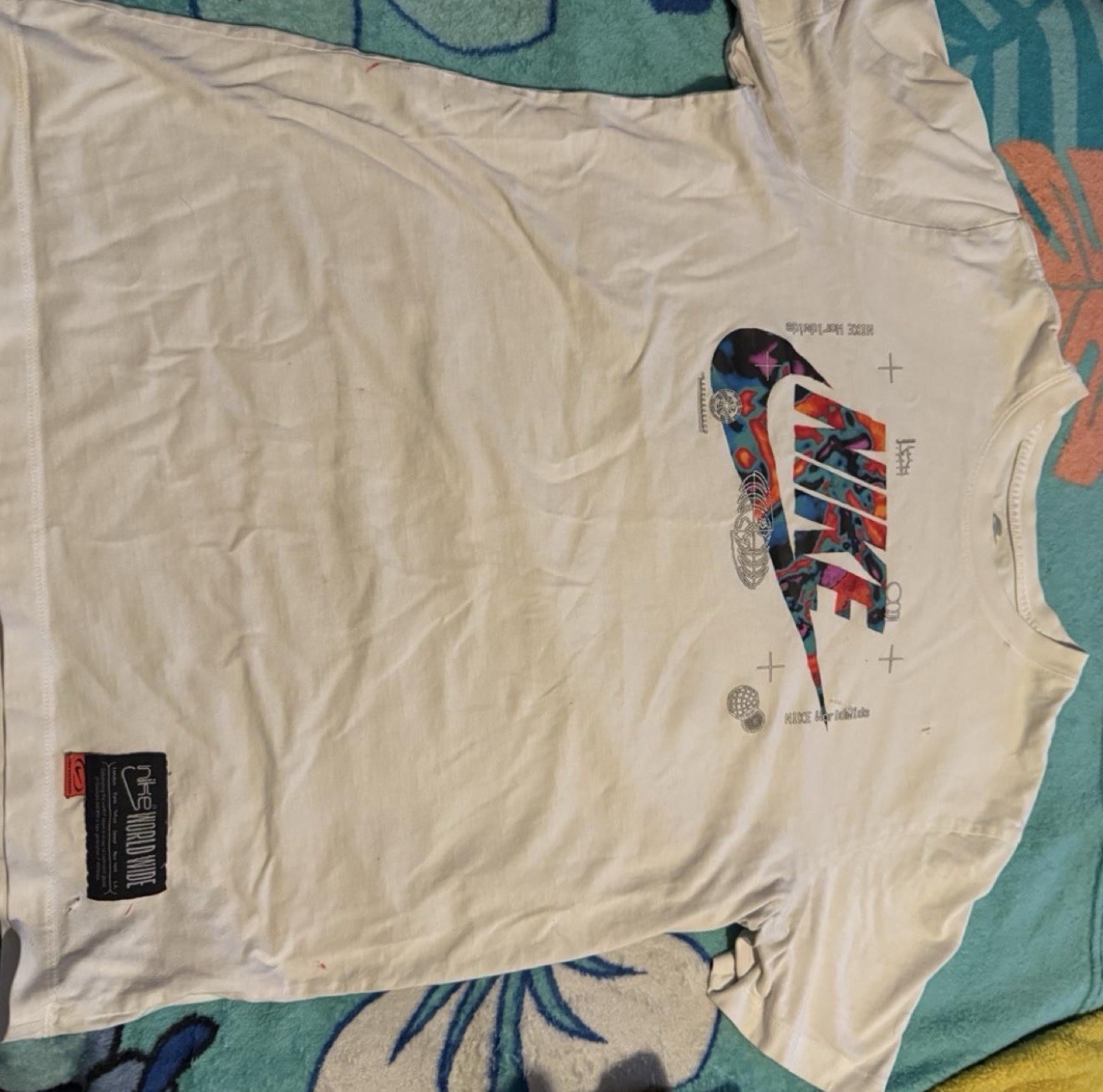 Nike world wide white t-shirt with multicolored Nike swoosh graphic