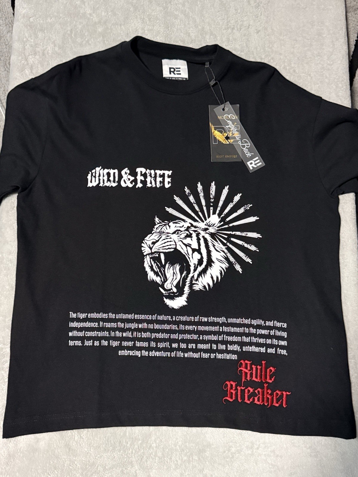 black cotton t-shirt features a bold red embroidered panther graphic Size Small