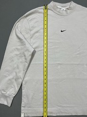 Nike long sleeve mock neck top in Light Bone featuring a small swoosh logo