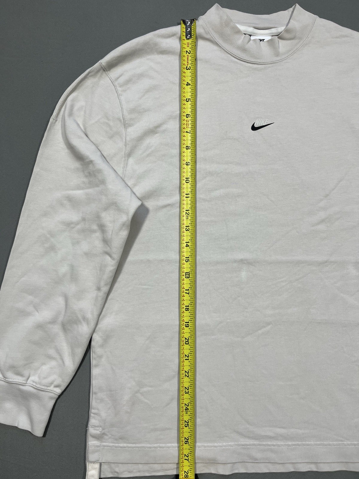 Nike long sleeve mock neck top in Light Bone featuring a small swoosh logo gallery