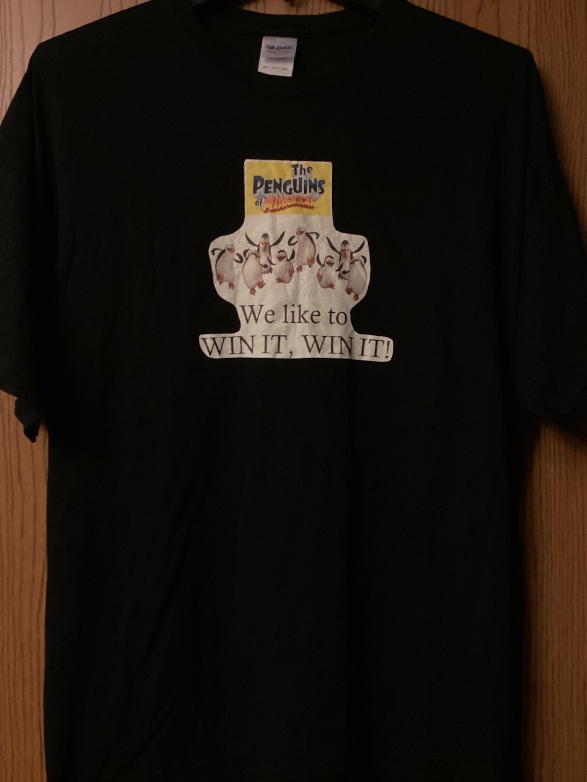 The Penguins Of Madagascar – “We Like To Win It, Win It” – Black Shirt – 2XL