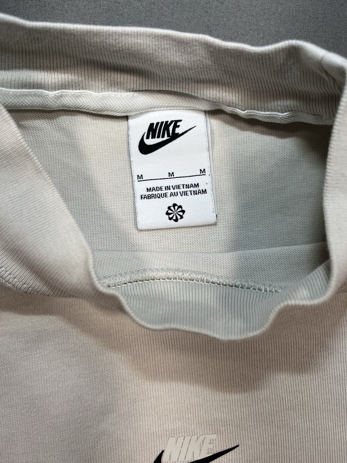 Nike long sleeve mock neck top in Light Bone featuring a small swoosh logo gallery