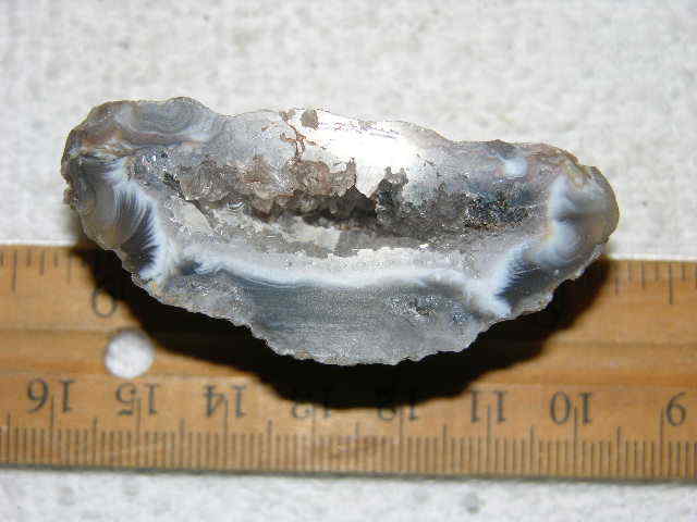 Agate geode half cut and polished with druzy crystal filled center 2″ U9