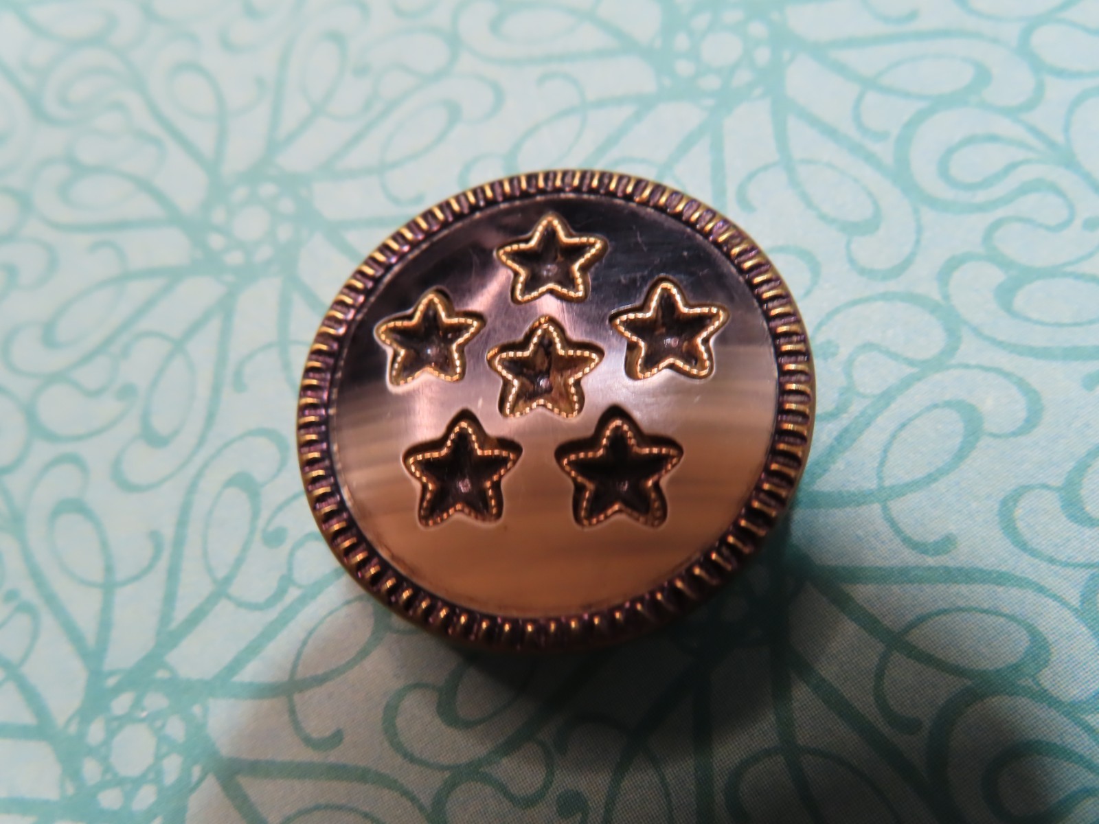 Vintage BUTTON*Medium metal with sheet celluloid, pierced stars (O6)